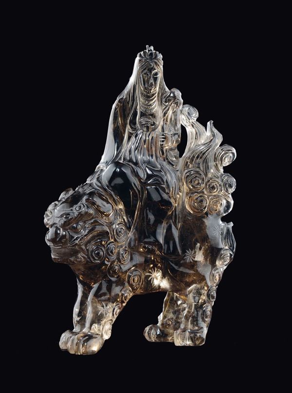 A smoky rock crystal figure of Guanyin on Pho dog, China, 20th century