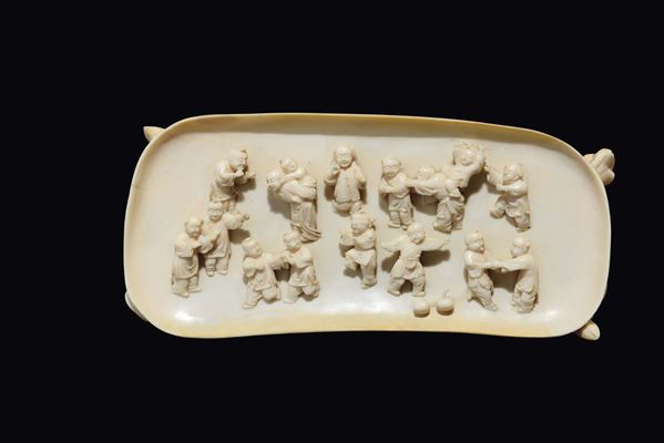 A carved ivory playing children plaque, China, Qing Dynasty, 19th century