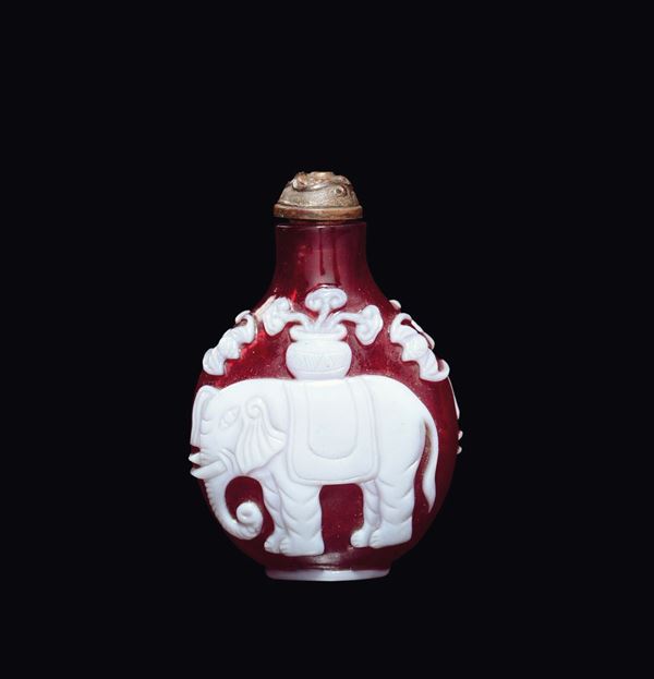 A white-overlay red Beijing glass snuff bottle with elephant, China, Qing Dynasty, 19th century