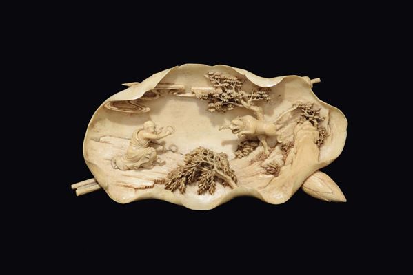 A carved ivory finger citron leaf with monk and jumping tiger group, China, Qing Dynasty, Qianlong Period (1736-1795)