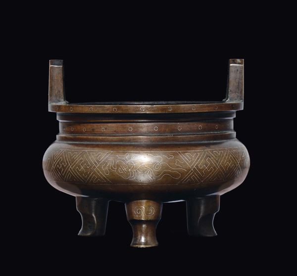 A bronze tripod two-handled censer, China, Qing Dynasty, 18th century