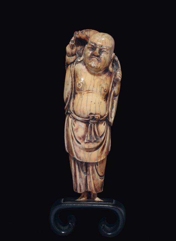 A carved ivory figure of Budai with hat, China, Ming Dynasty, 17th century