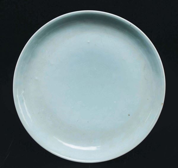 A porcelain dish with engraved naturalistic decoration, China, Qing Dynasty, 19th century