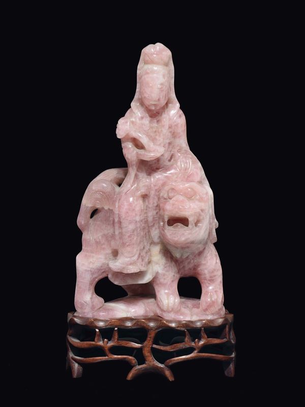 A rose quartz figure of Guanyin with ruyi on Pho dog, China, Qing Dynasty, 19th century