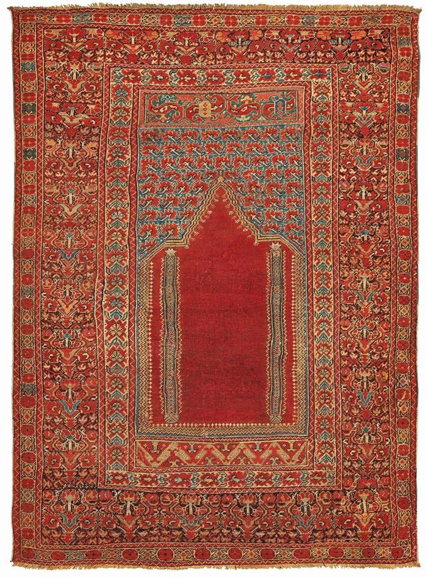 A Ghiordes prayer rug early 19th century cm 170x130. Sides not originally.