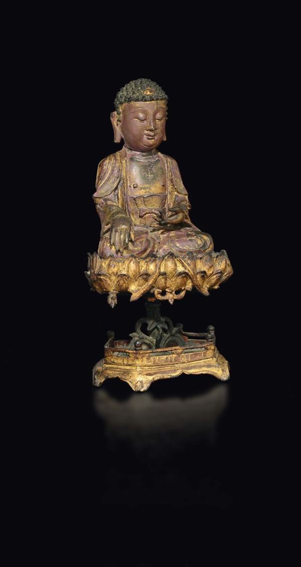 A large semi-gilt bronze figure of Buddha seated on a lotus flower stand, China, Ming Dynasty, 17th century