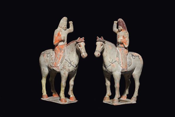 A pair of painted pottery figures of horsemen, China, Tang Dynasty (618-906)