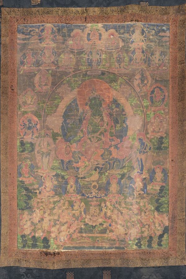 Tanka su seta a fondo blu e verde con divinità centrale su fiore di loto, Tibet, XVIII secolo