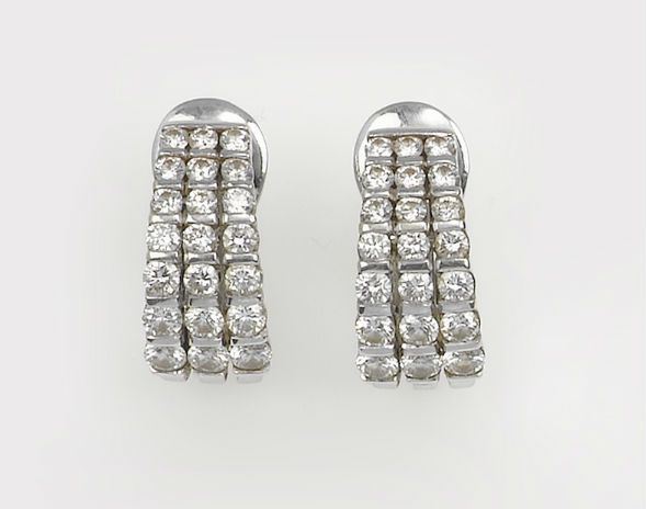 A pair of diamond and gold earrings