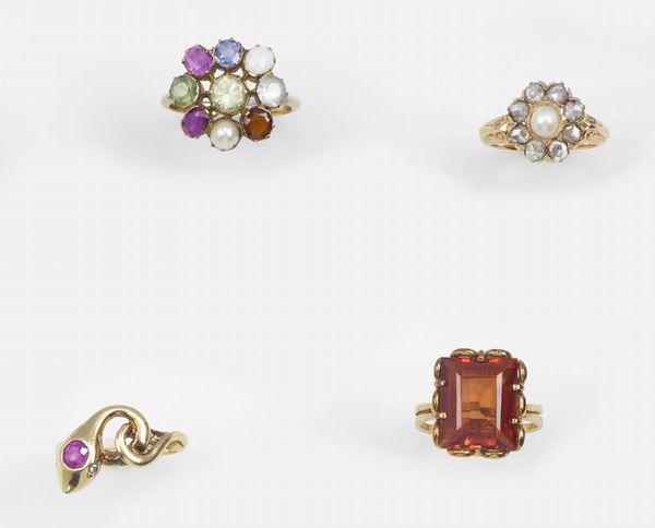 Lot composed by four gold and gem-set rings (one with a synthetic corundum)