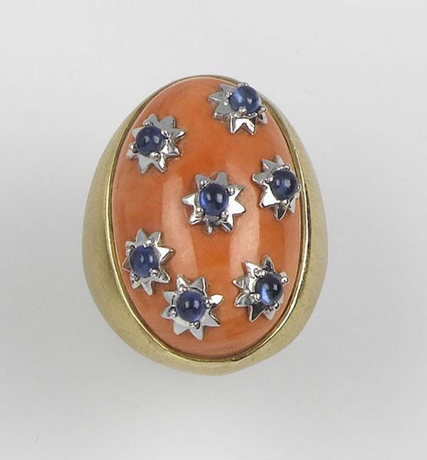 A coral and sapphire ring