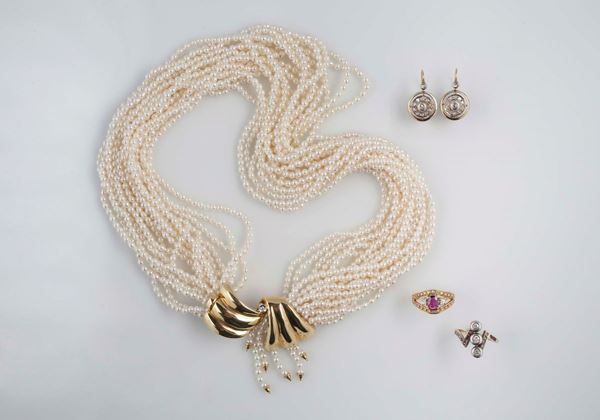 Two rings, a multi-strand pearl necklace and a pair of earrings