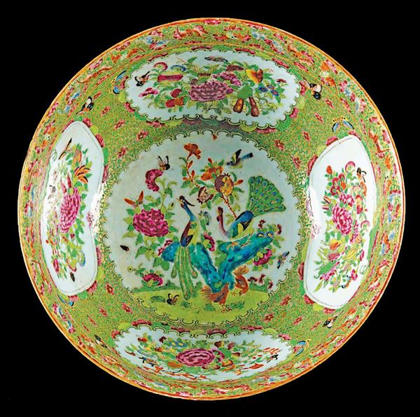 A polychrome enamelled porcelain bowl with peacocks betwen flowers, China, Qing Dynasty, 19th century