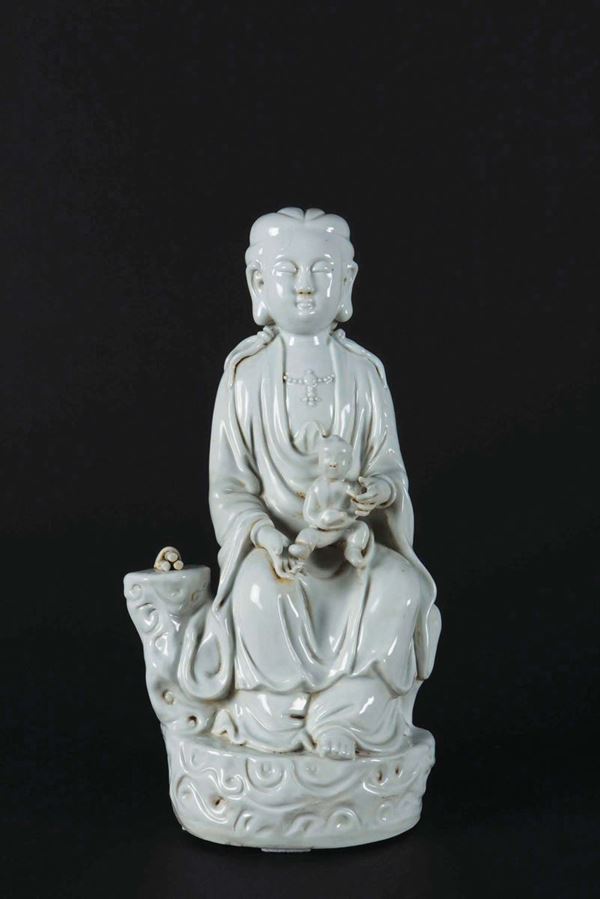 Figura di Guanyin seduta in porcellana Blanc de Chine con fanciullo, Cina, XX secolo