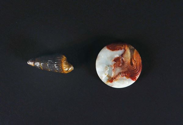A white and russet jade Pi and a yellow jade shell snuff bottle, China, Qyng Dynasty, late 19th century