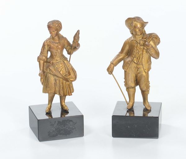 Due sculture in bronzo dorato raffiguranti figure, XX secolo