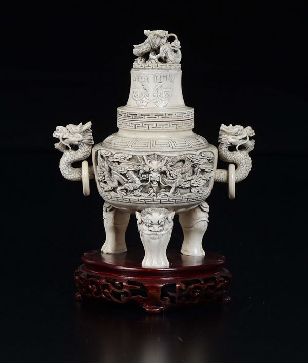 A carved ivory tripod censer and cover with dragons in relief, China, early 20th century
