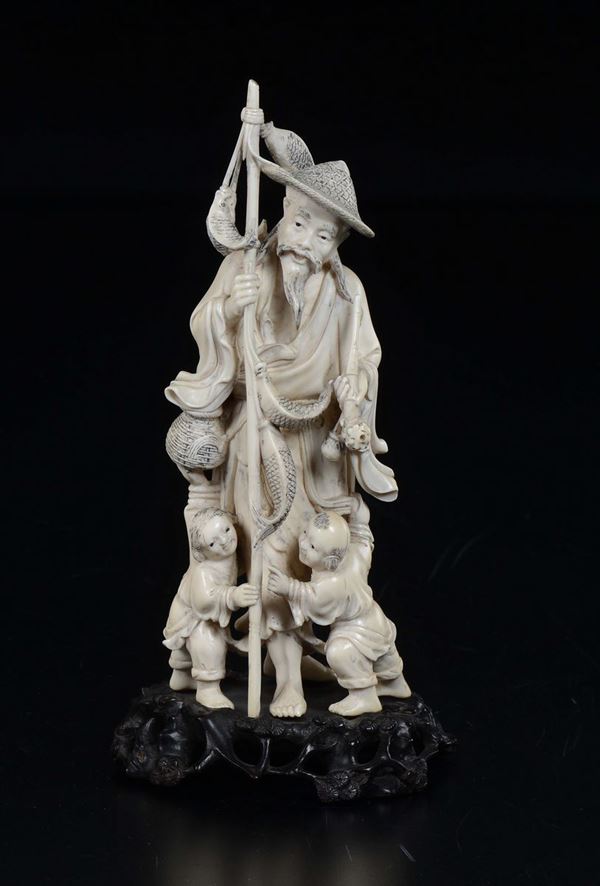 A carved ivory figure of fisherman with children, China, early 20th century
