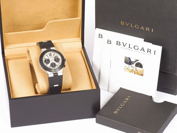 BULGARI, Alluminium, Ref. AC 38 TA,  self-winding, water-resistant, aluminium and rubber wristwatch with oval button chronograph, registers, date, on hinged rubber and aluminium strap with aluminium Bulgari buckle. Made circa 2000. Accompanied by the original  box and Instruction booklet.