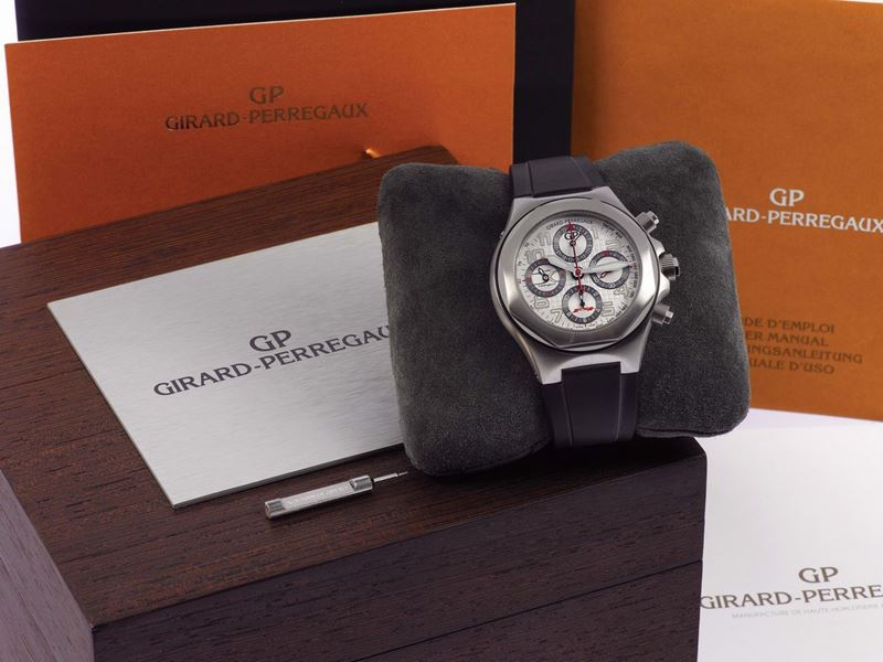 GIRARD-PERREGAUX , Laureato Evo3'', F4 Agusta, No. 20/20, Ref. 80180, self-winding, water-resistant,  perpetual calendar, stainless steel wristwatch with round button chronograph, 12-hour and central 60-minute registers, 24 hour indication and a steel Girard- Perregaux double deployant clasp. Accompanied by Girard- Perregaux box, certificate, Guarantee, push pin and instruction booklet. Made in a limited edition of 20 pieces.  - Auction Watches and Pocket Watches - Cambi Casa d'Aste