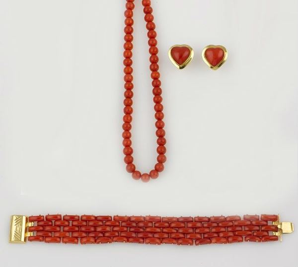 A group including a coral necklace, a coral bracelet and a coral pair of earrings