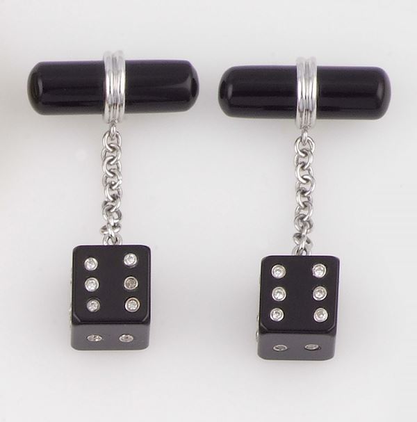 A pair of onyx and diamond cufflinks