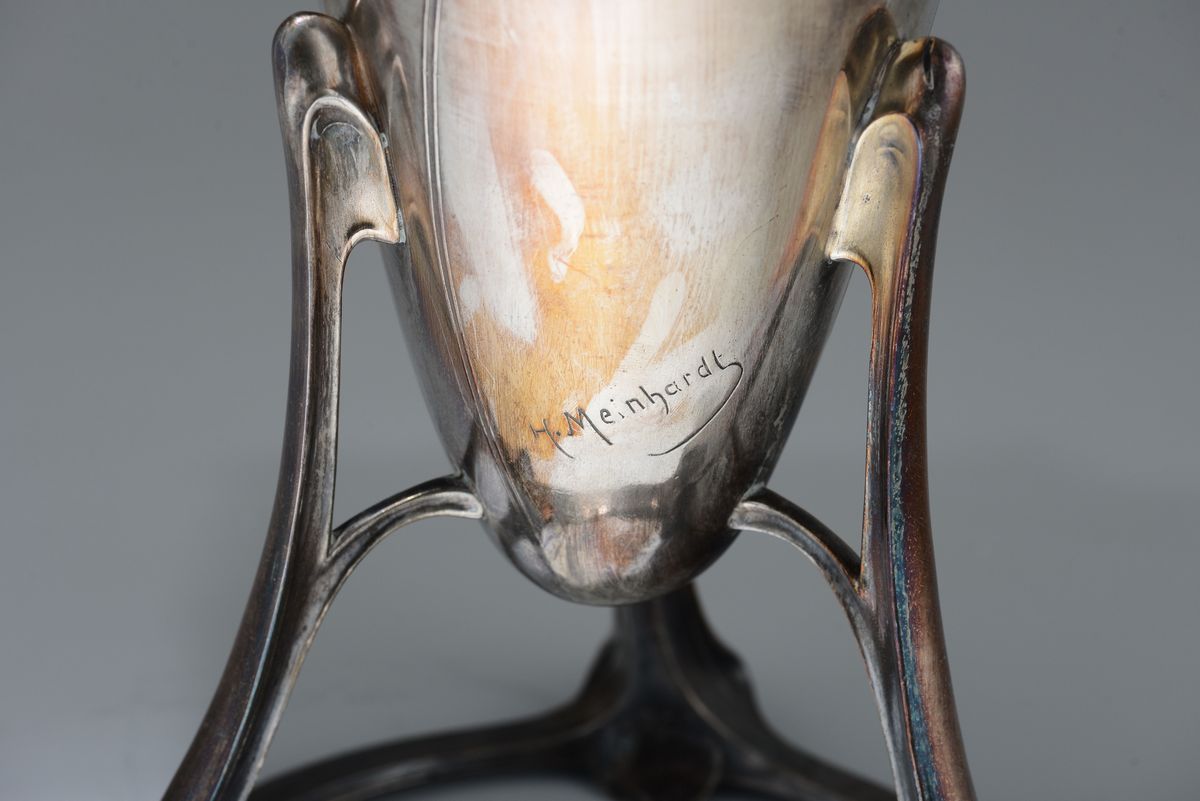Meinhardt, Grande vaso a forma di anfora su tripode, metallo argentato con figure in alto rilievo