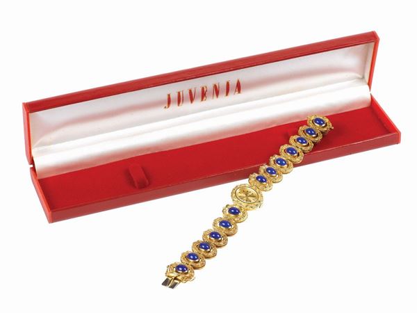 JUVENIA, case No. 844856, 18K yellow gold lady's wristwatch with an 18K yellow gold and lapis bracelet. Accompanied by the original box and Guarantee. Made circa 1960