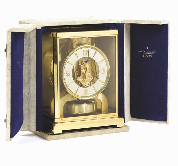 Jaeger-LeCoultre, Atmos. Made in the 1970s. Fine, rectangular, gilt brass and glass Atmos clock wound by barometric pressure changes. Dial, case and movement signed. Accompanied by the original box and instruction booklet