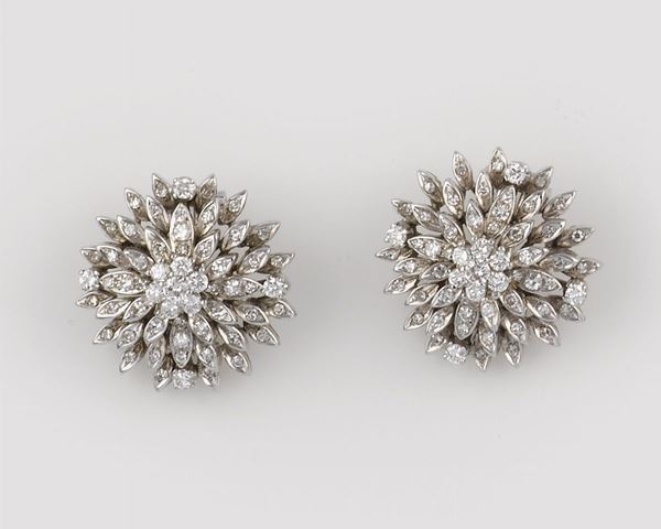 A pair of diamond and gold earrings