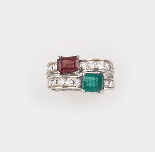 An emerald, garnet and diamond ring