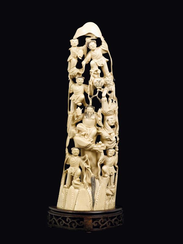 A carved ivory wise man and children group, China, Qing Dynasty, 19th century