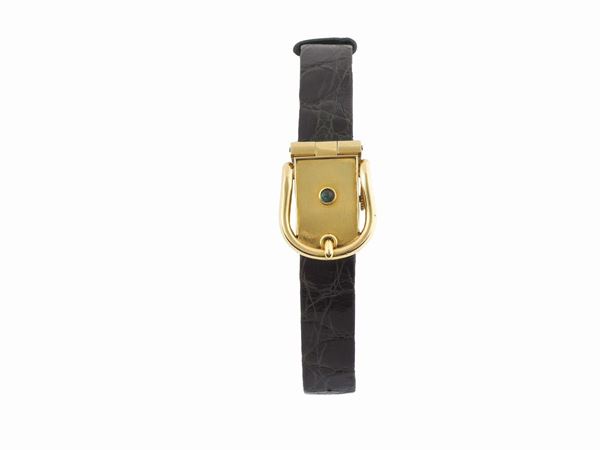 HERMES, Paris, No. 49341, 18K yellow gold lady's wristwatch with concealed dial and case  in the shape of a belt and  and 18K yellow gold buckle. Made circa 1950