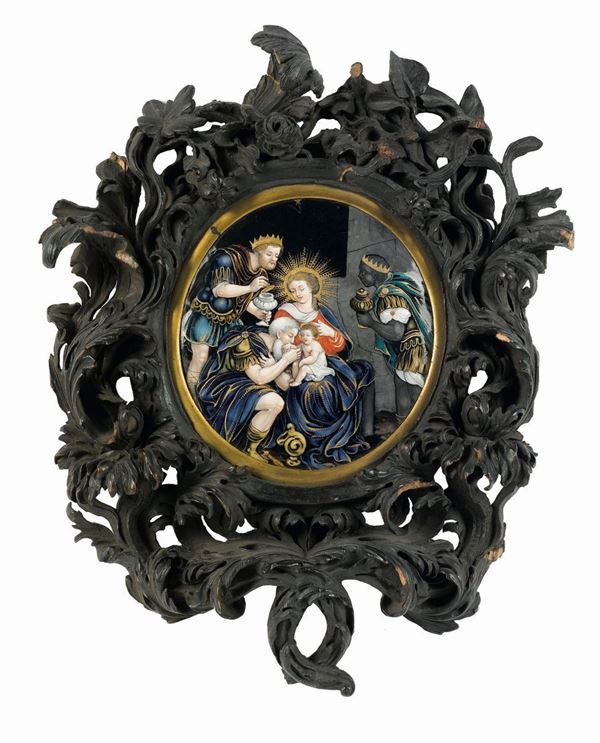 Placca in smalti policromi raffigurante Adorazione dei Magi entro cornice in legno intagliato. Limoges XVII secolo