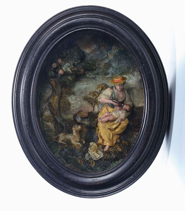 Maternal Love. Polychrome wax picture within an ebonised oval wooden frame