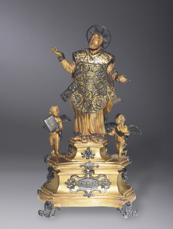 Gruppo di figure in bronzo fuso, cesellato, dorato e argentato, con pietre dure, raffigurante S. Filippo Neri con due angeli. Roma inizio XVIII secolo