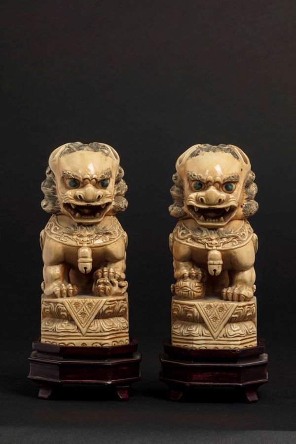 A pair of carved ivory Pho dogs, China, early 20th century
