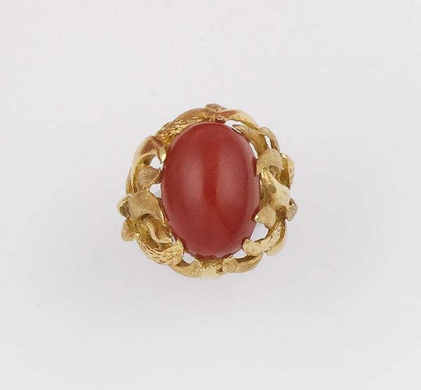 A coral and gold ring
