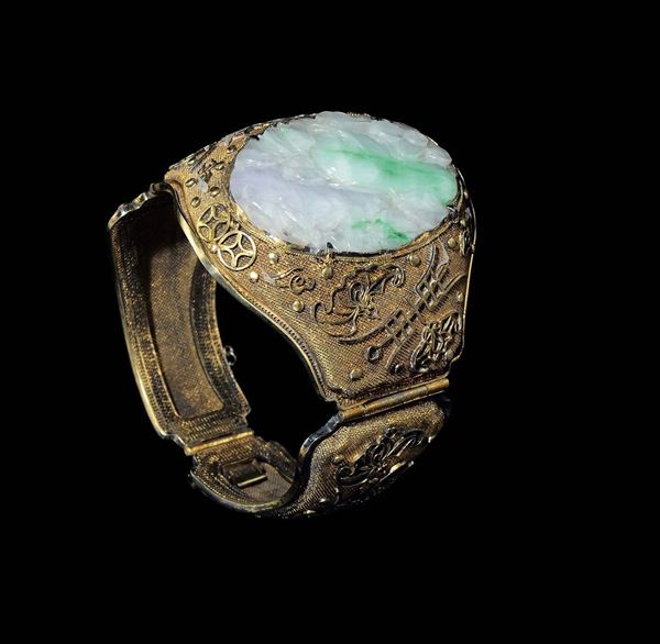 A bracelet with a jadeite plaque with naturalistic decoration, China, Qing Dynasty, 19th century