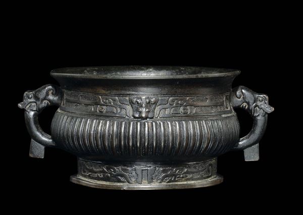 A bronze handeled censer with a geometric archaic style motif, China, Ming Dynasty, 17th century