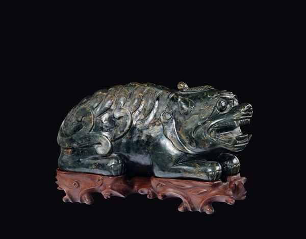 A large carved spinach green and russet jade Pho dog, China, Ming Dynasty, 17th century