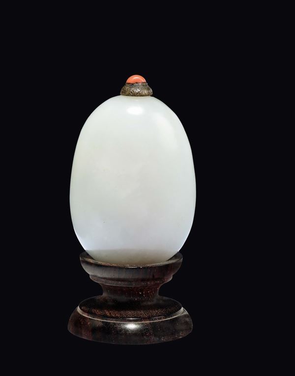 A white jade snuff bottle with silver and coral stopper, China, Qing Dynasty, Qianlong Period (1736-1795)