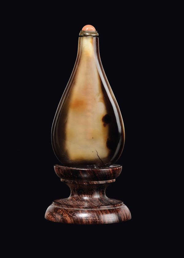 A tiger's-eye snuff bottle with coral stopper, China, Qing Dynasty, 19th century