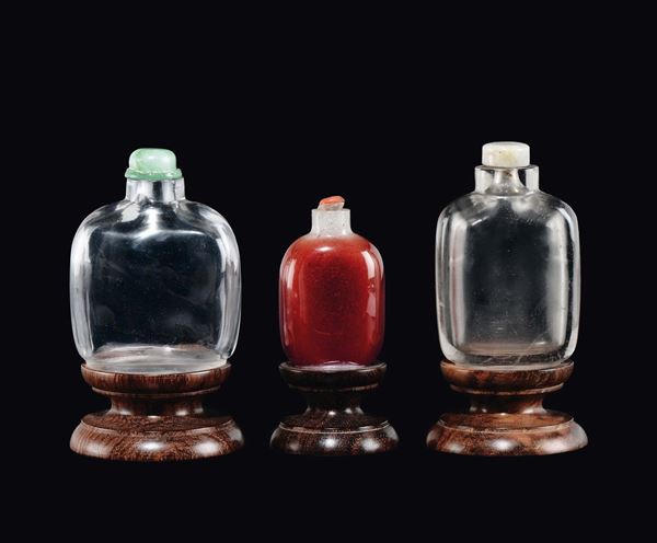 Lotto di tre snuff bottles, due in cristallo di rocca ed una in vetro rosso, Cina, Dinastia Qing, XIX secolo