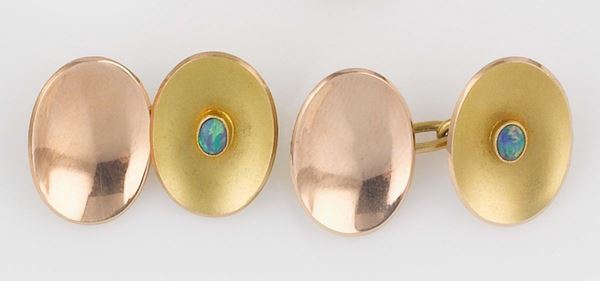 A pair of gold and opal cufflinks