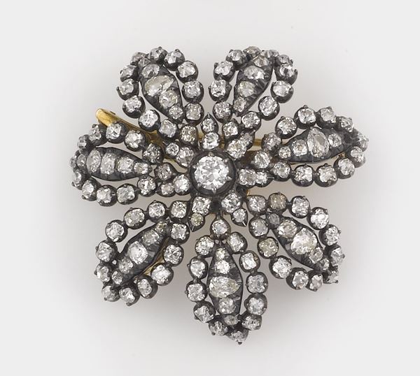 A diamond, gold and silver brooch/pendant
