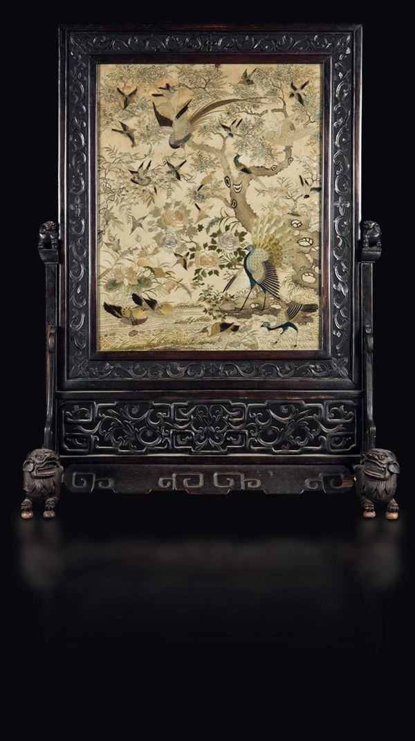A carved wood firescreen with a silk cloth embroidered with birds, peacocks and roses, China, Qing Dynasty, 19th century