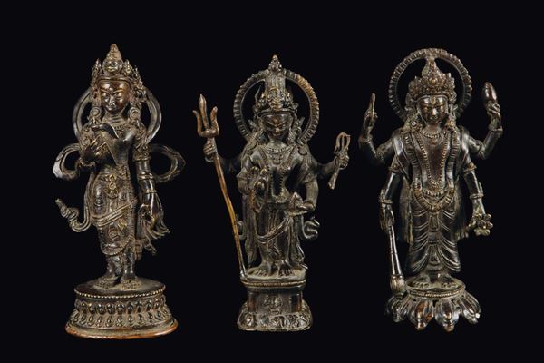 Three bronze standing deities with aura, Nepal, 18th century