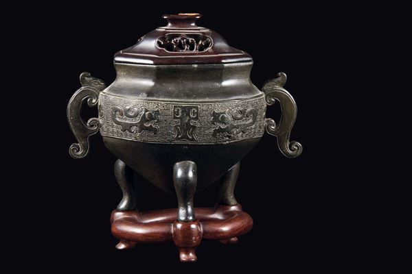 A bronze tripod censer and wooden cover with a geometric archaic style motif, China, Ming Dynasty, 17th century