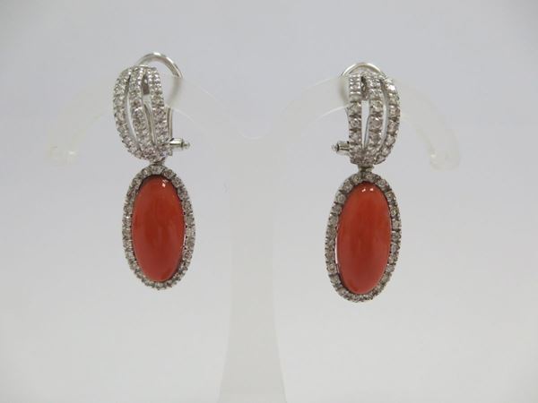 A pair of coral and diamond earrings